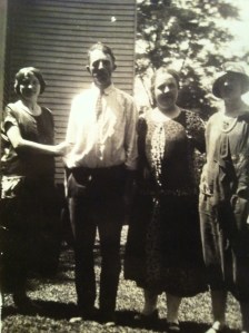 Nora Pack Brumfield, Bob "Jaker" Brumfield, Ethel Brumfield, and Jessie Brumfield, standing by the Charley Brumfield house in Harts, Lincoln County, WV, 1920s