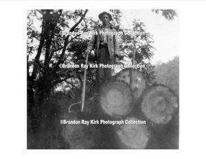 Cecil Brumfield, son of John and Harriet (Dingess) Brumfield, stands atop logs, Logan County, WV