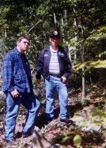 Jimmy McCoy with son at the Haley-McCoy grave on West Fork of Harts Creek, Lincoln County, WV, 1997
